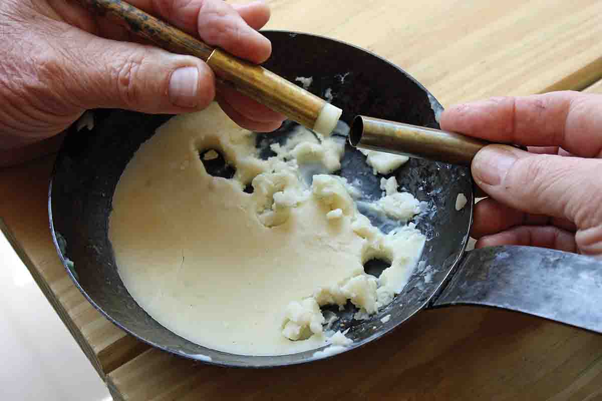 The tallow lube used in the hunting load is very soft, so Harvey packed the tallow inside a headless case and used a dowel to push out the length of tallow needed which was then inserted into the case and swiped off. The bullet, when seated, pushes the wad to its correct position.